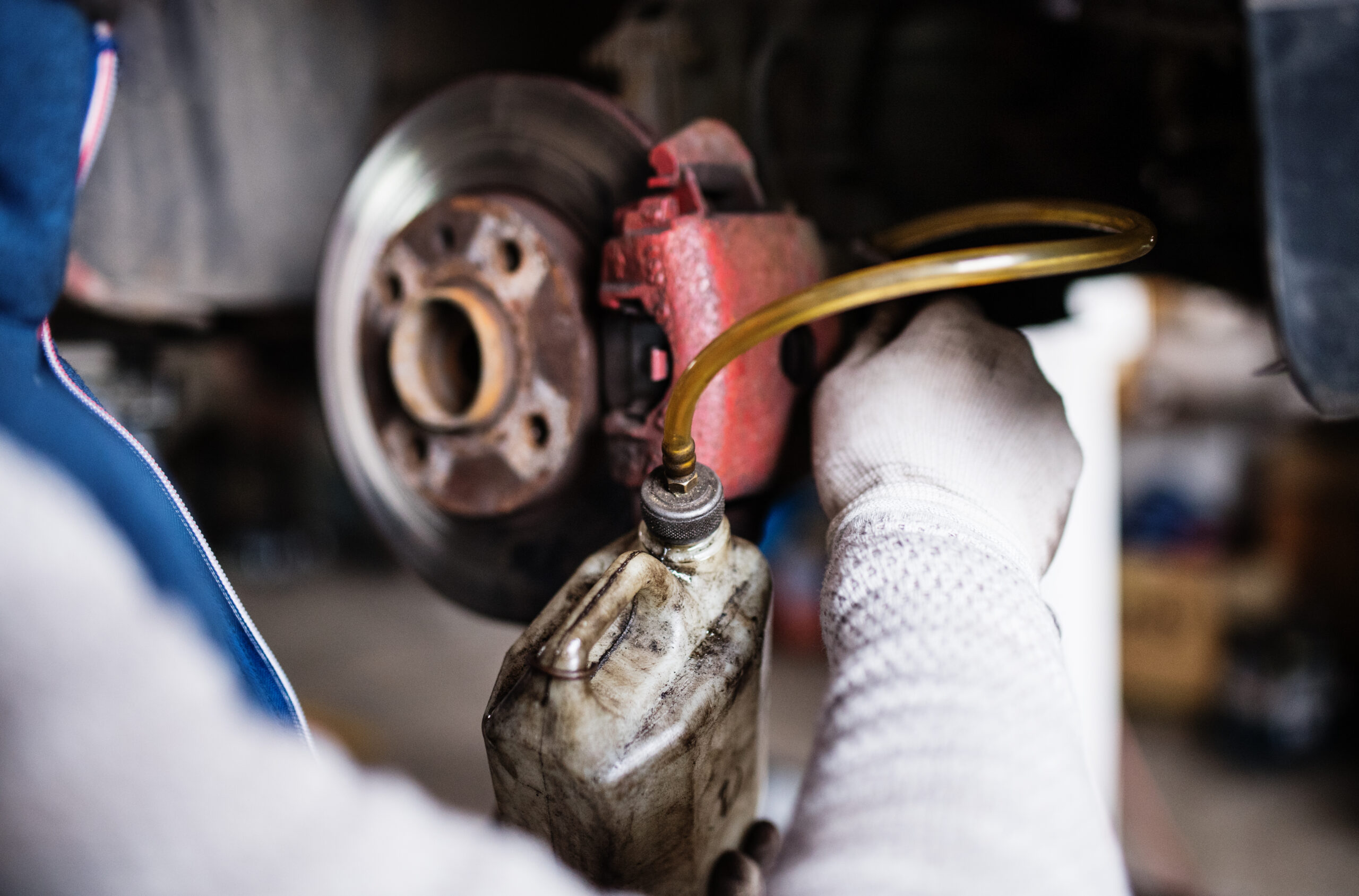 Mechanic inspecting car radiator cooling system components