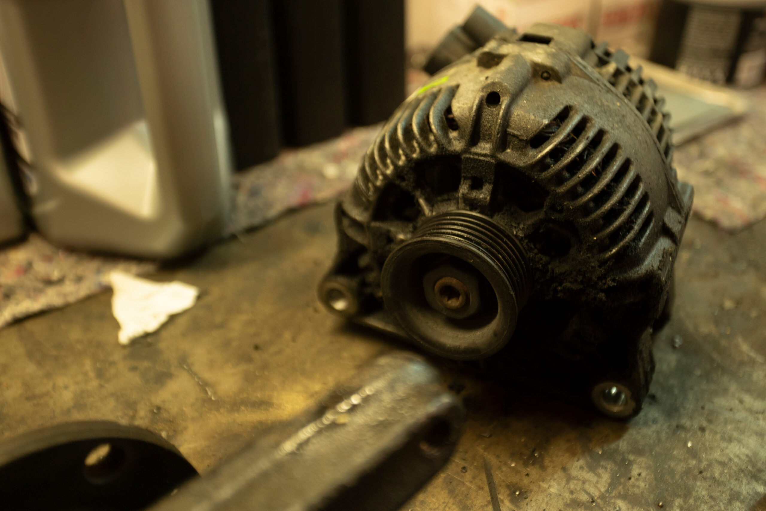 Mechanic inspecting a car alternator and starter motor